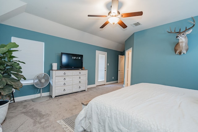 bedroom with visible vents, carpet, baseboards, and vaulted ceiling