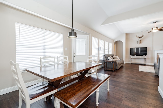 dining space with baseboards, arched walkways, lofted ceiling, and dark wood-style flooring