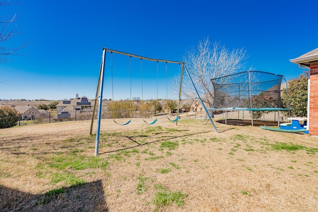 exterior space with a trampoline and fence