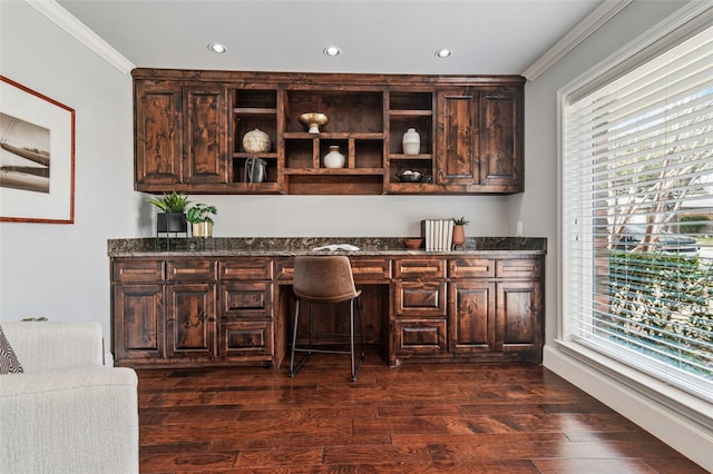 home office featuring recessed lighting, dark wood-style flooring, built in desk, and ornamental molding