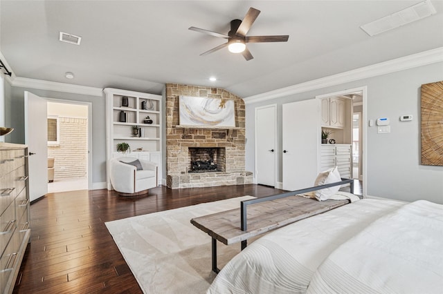 bedroom featuring visible vents, a stone fireplace, and ornamental molding