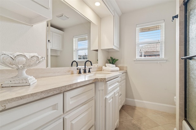 bathroom with baseboards, toilet, a shower with shower door, tile patterned floors, and vanity