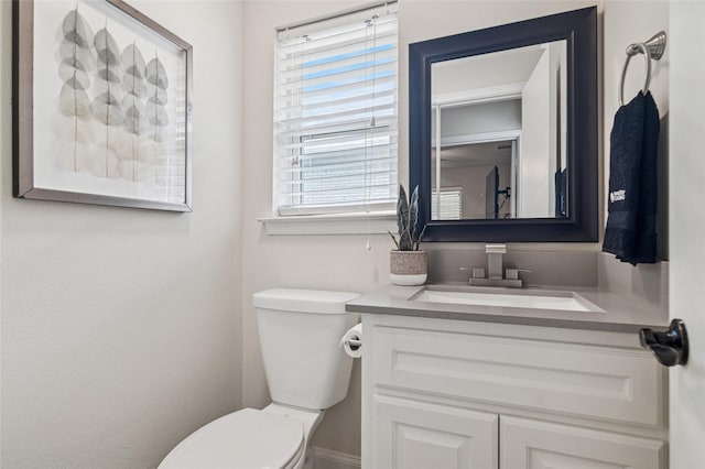 bathroom with toilet and vanity