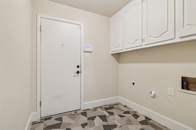 laundry area featuring electric dryer hookup, baseboards, cabinet space, and light floors