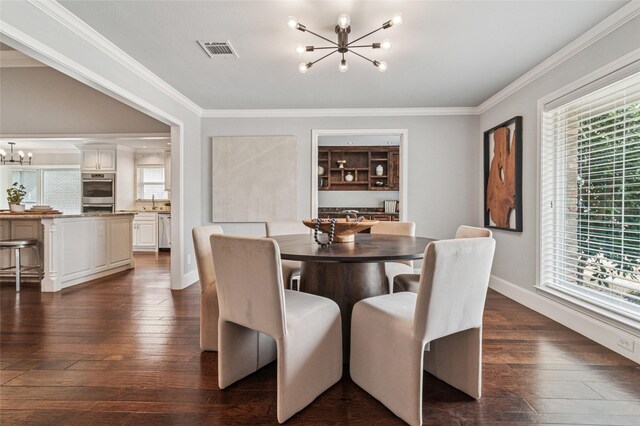 dining space with crown molding, a notable chandelier, and a wealth of natural light