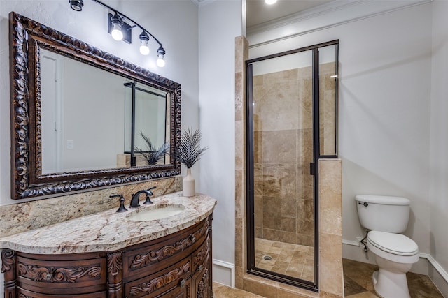 bathroom with vanity, toilet, baseboards, and a stall shower