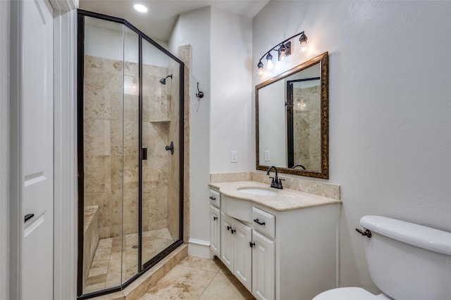 full bath with vanity, tile patterned floors, toilet, and a stall shower