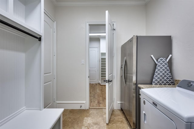 laundry area featuring washer / dryer, ornamental molding, and laundry area