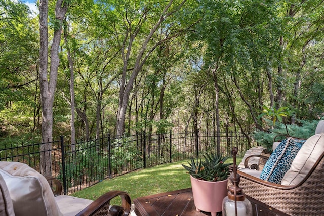 wooden terrace with a yard and fence