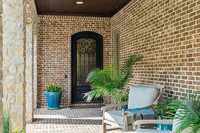 entrance to property with brick siding