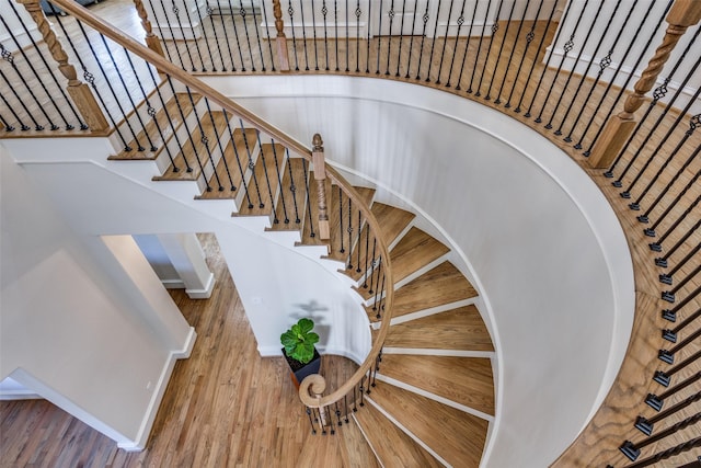 stairway featuring baseboards and wood finished floors