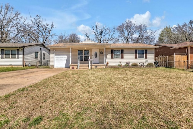 ranch-style home featuring driveway, an attached garage, a front lawn, and fence