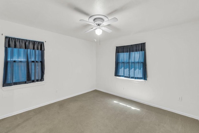 spare room featuring baseboards, a ceiling fan, and carpet flooring