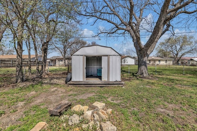 view of yard with an outdoor structure, a storage unit, and a fenced backyard