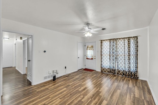 empty room with visible vents, baseboards, wood finished floors, and a ceiling fan