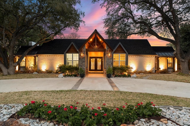 view of front of house featuring french doors and brick siding