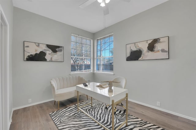 office space with a ceiling fan, wood finished floors, and baseboards