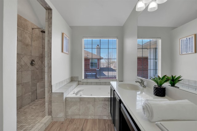 full bathroom featuring a garden tub, lofted ceiling, a sink, double vanity, and tiled shower