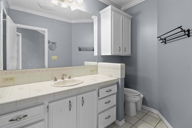 bathroom with tile patterned floors, toilet, vanity, and ornamental molding