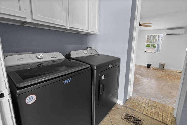 clothes washing area with visible vents, a wall mounted air conditioner, washer and dryer, cabinet space, and a ceiling fan