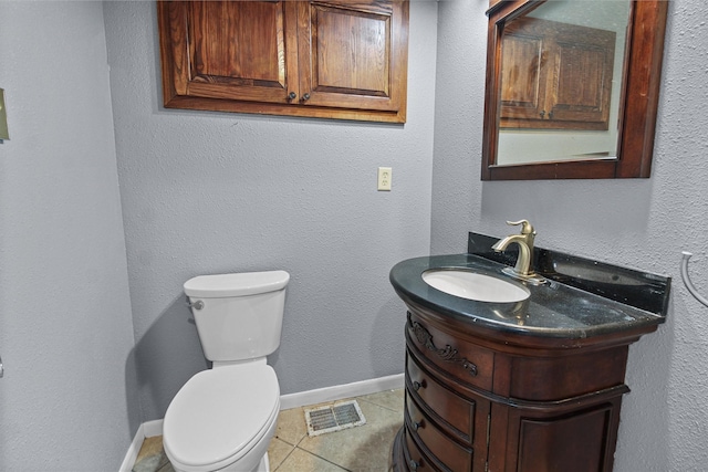 half bathroom with visible vents, baseboards, toilet, tile patterned floors, and vanity