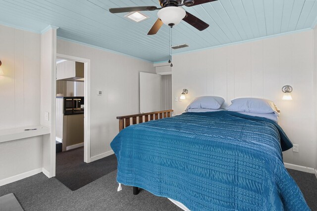 carpeted bedroom with visible vents, baseboards, crown molding, and ceiling fan