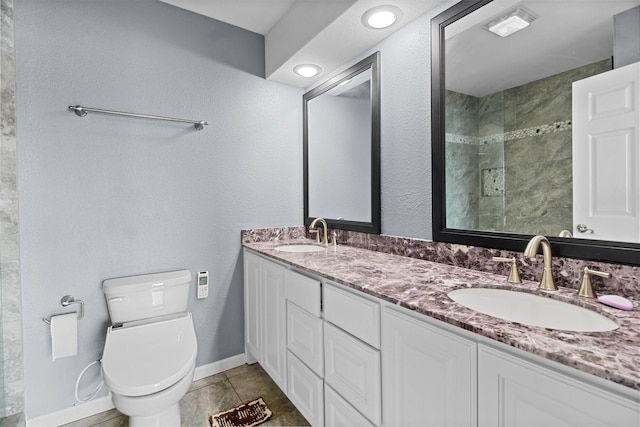 full bathroom featuring tile patterned floors, toilet, baseboards, and a sink