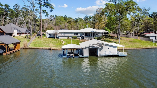 view of dock featuring boat lift, a yard, and a water view