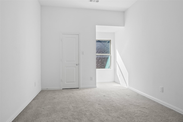 spare room featuring visible vents, baseboards, and carpet flooring