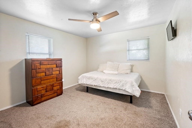 bedroom with a ceiling fan, carpet, and baseboards
