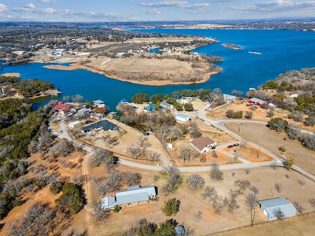 aerial view of property and surrounding area featuring a nearby body of water