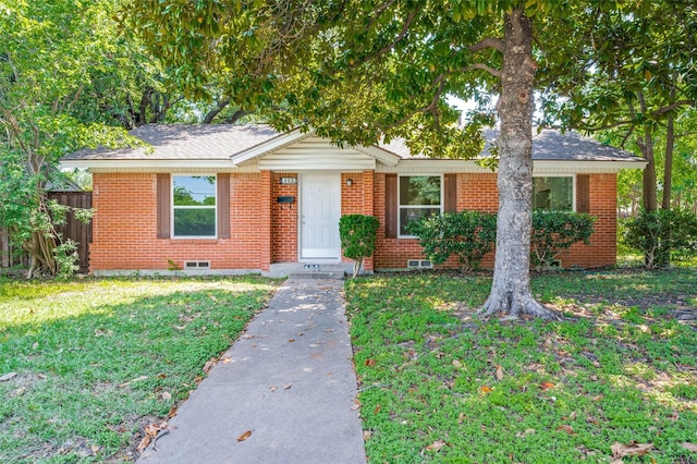 single story home with brick siding, a shingled roof, a front lawn, and fence