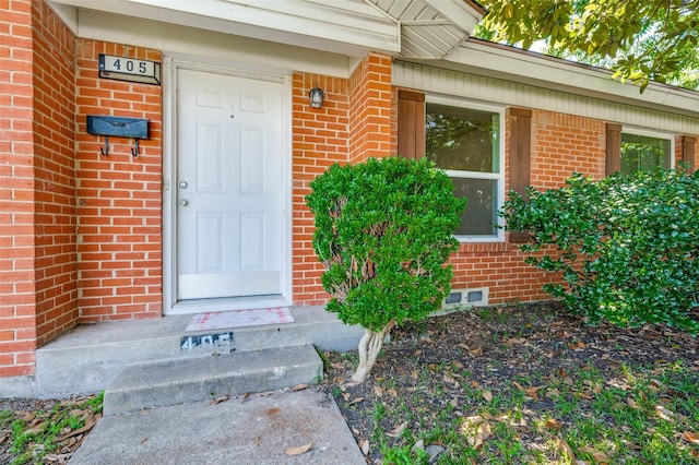 property entrance with brick siding