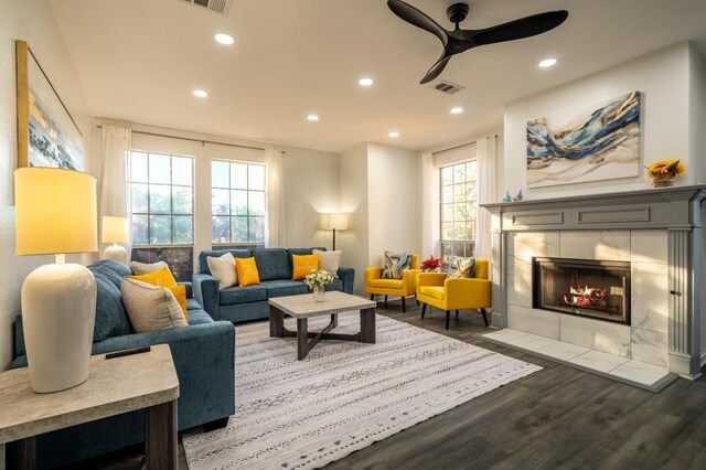 living area featuring recessed lighting, a ceiling fan, wood finished floors, and a fireplace