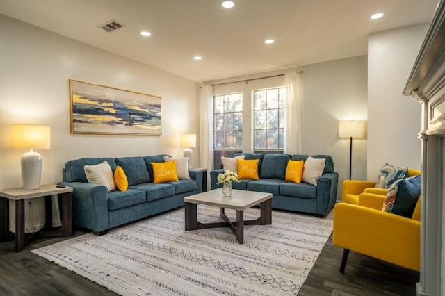 living room with recessed lighting, visible vents, and wood finished floors