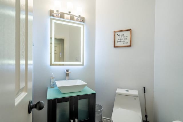 bathroom featuring vanity and toilet