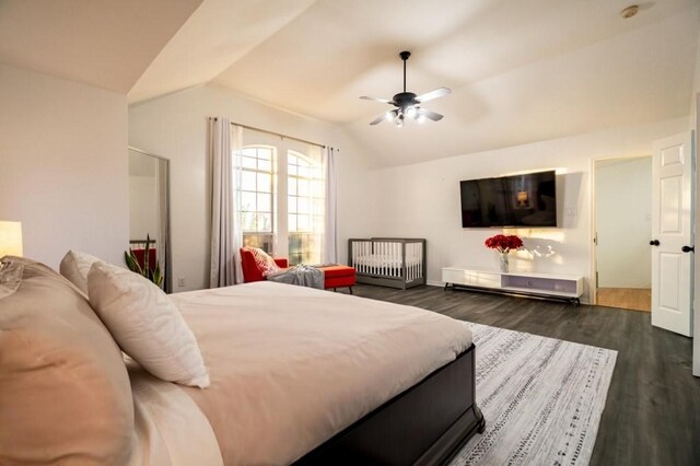 bedroom with ceiling fan, dark wood-style floors, and vaulted ceiling