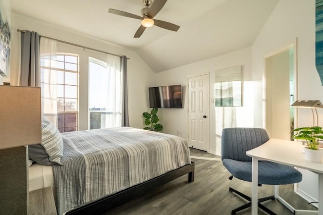 bedroom featuring a ceiling fan, lofted ceiling, and wood finished floors