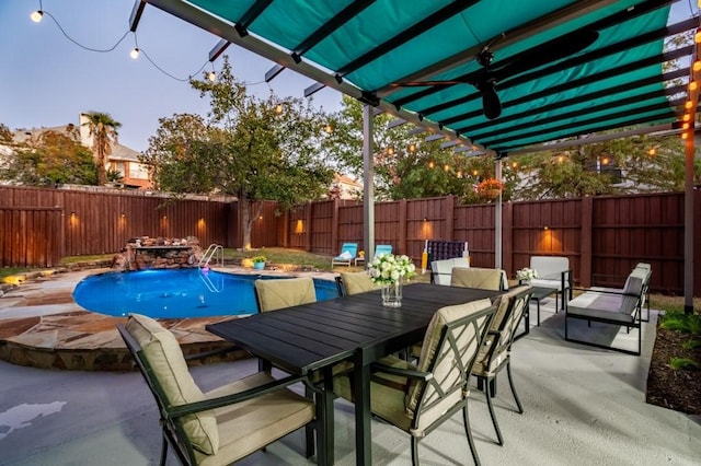 view of swimming pool with a fenced in pool, a fenced backyard, outdoor dining space, and a patio area