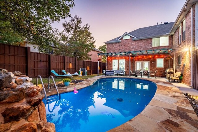 view of swimming pool featuring a patio, a fenced in pool, french doors, and fence