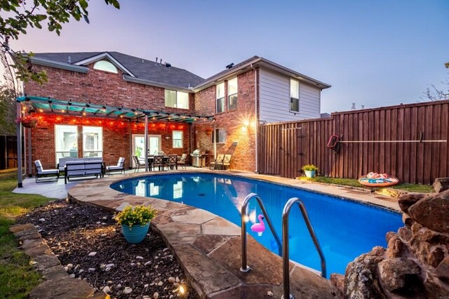 view of swimming pool with a patio area, a fenced backyard, and a fenced in pool