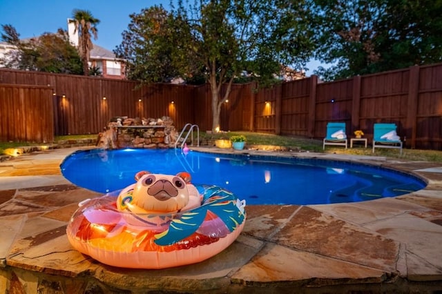 view of swimming pool featuring a patio area, a fenced in pool, and a fenced backyard