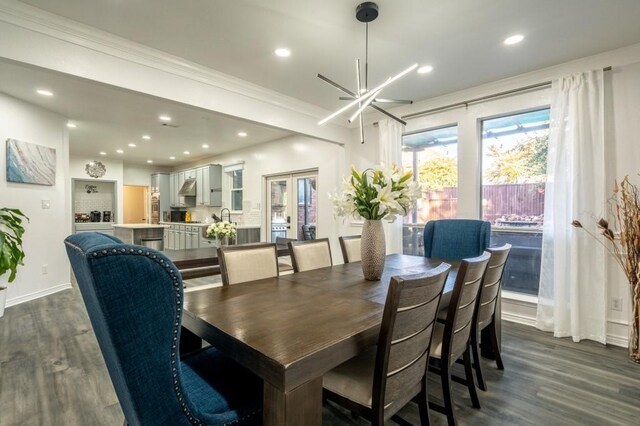 dining room with a notable chandelier, dark wood-style floors, recessed lighting, french doors, and crown molding