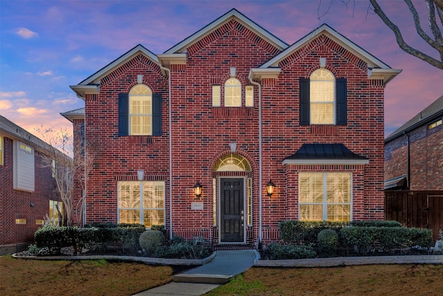 traditional-style house featuring brick siding