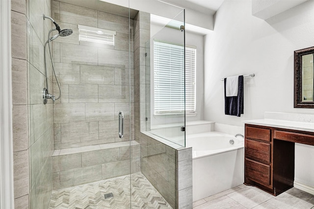 bathroom with a shower stall, a bath, and vanity