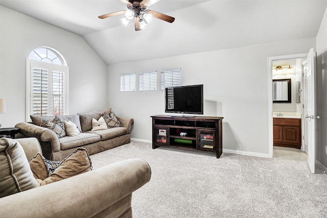 living room with light colored carpet, baseboards, a ceiling fan, and vaulted ceiling