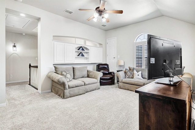 living room featuring visible vents, baseboards, light colored carpet, attic access, and ceiling fan