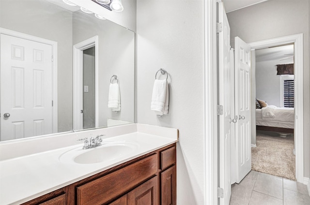 ensuite bathroom with tile patterned floors, vanity, and ensuite bath