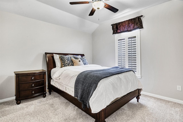 bedroom with light colored carpet, a ceiling fan, baseboards, and vaulted ceiling