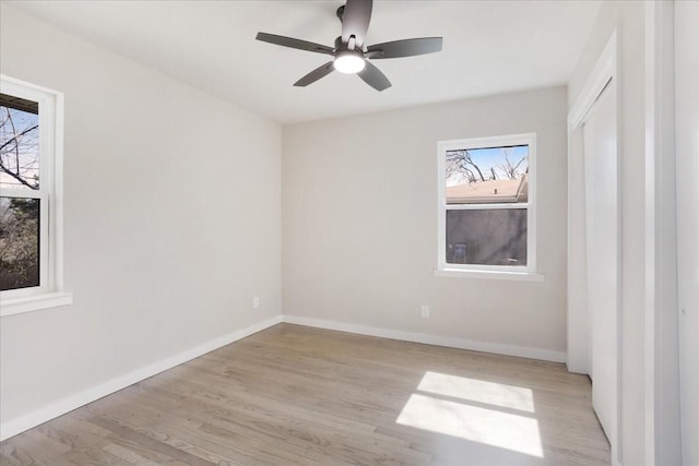 interior space featuring plenty of natural light, wood finished floors, and baseboards